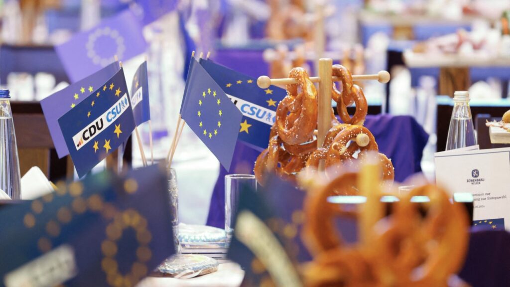 Pretzels and flags of the European Union with logos of the CDU and CSU parties before the start of the last rally for European elections in Munich on June 7, 2024.