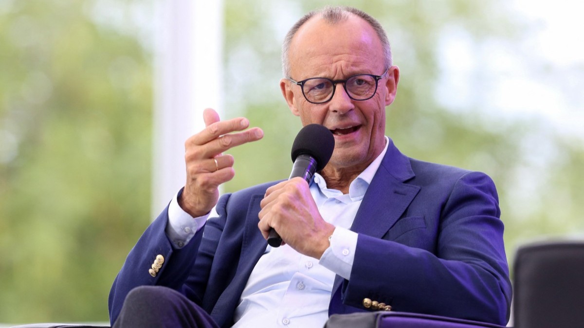 German Chancellor Friedrich Merz speaks on stage during a discussion as part of the annual Open Day event at the Chancellery in Berlin, on August 24, 2025.
