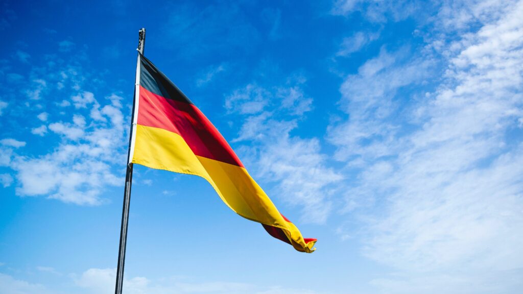 The German flag seen against a blue sky