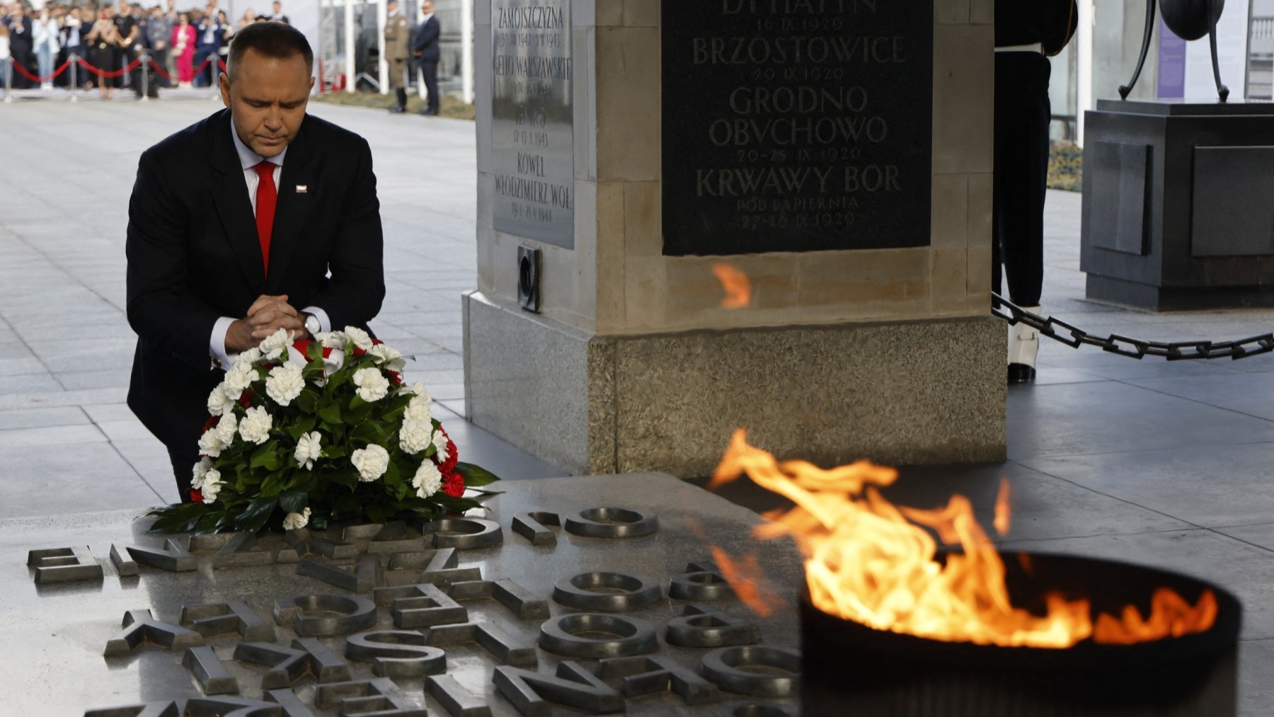 Poland’s President Karol Nawrocki kneels at the Tomb of the Unknown Soldier on the Pilsudski square in Warsaw, during an official ceremony to assume command of the Armed Forces on August 6, 2025.