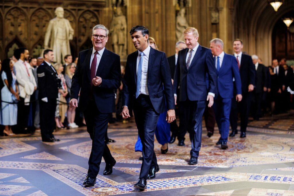 Britain's Prime Minister Keir Starmer (L) and Britain's Conservative Party opposition leader Rishi Sunak (R) speak together as they process through the Central Lobby during the State Opening of Parliament at the Houses of Parliament, in London, on July 17, 2024.