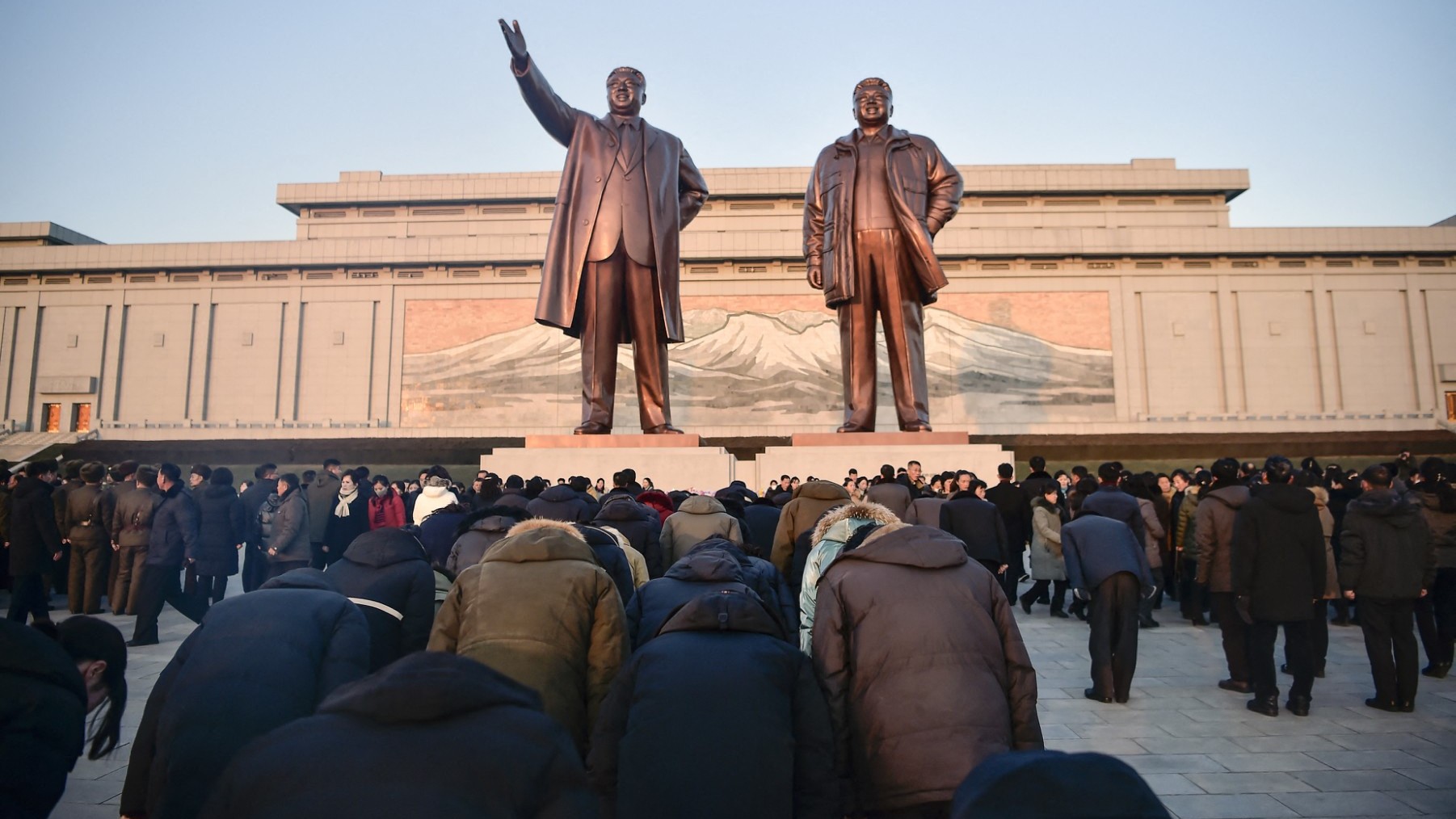 People visit Mansu Hill to pay their respects in front of statues of late North Korean leaders Kim Il Sung and Kim Jong Il, to mark the thirteenth anniversary of the death of Kim Jong Il, the father of current leader Kim Jong Un, in Pyongyang on December 17, 2024.