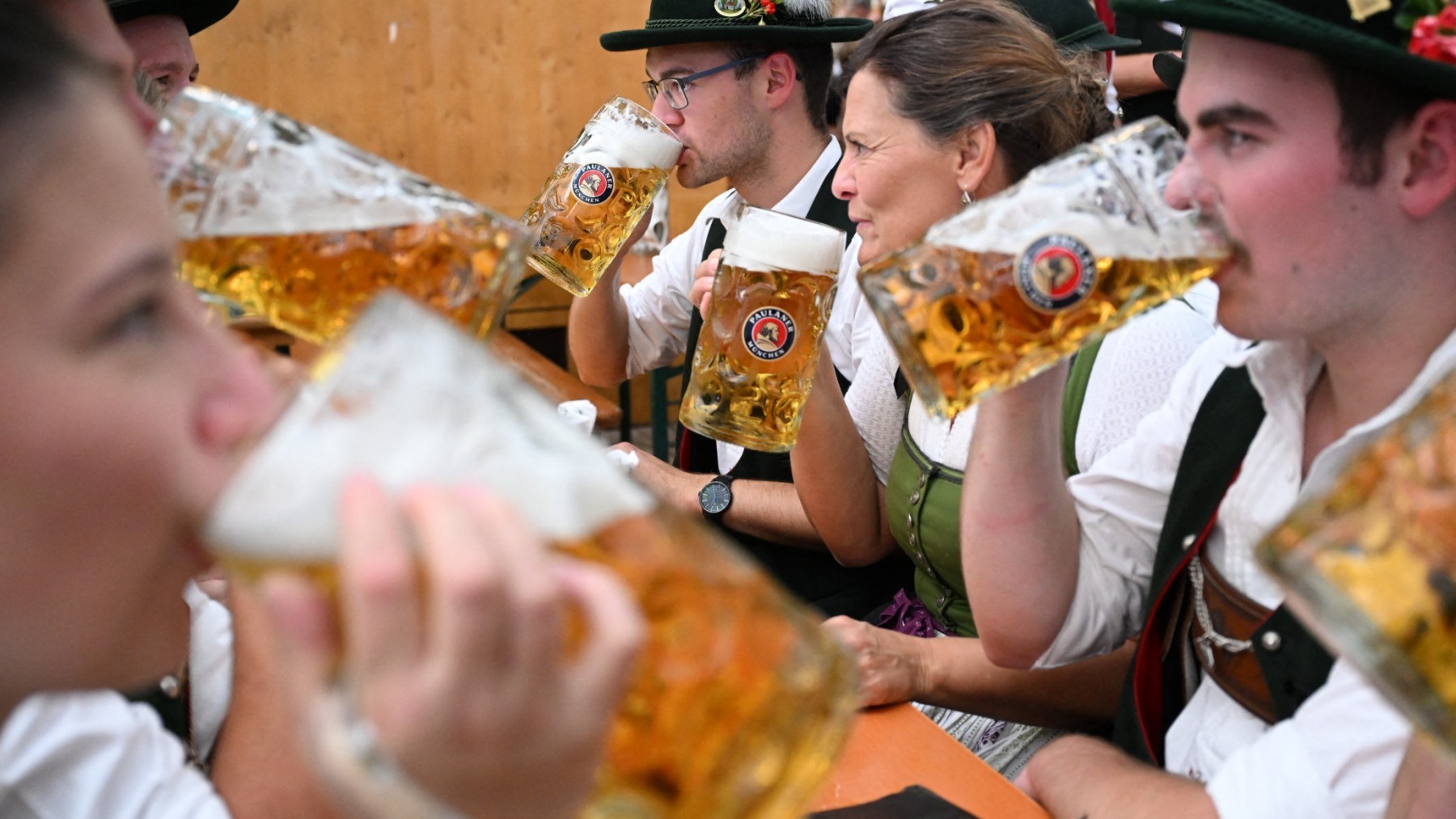 People drink beer during the Oktoberfest beer festival in Munich, southern Germany, on September 22, 2024.