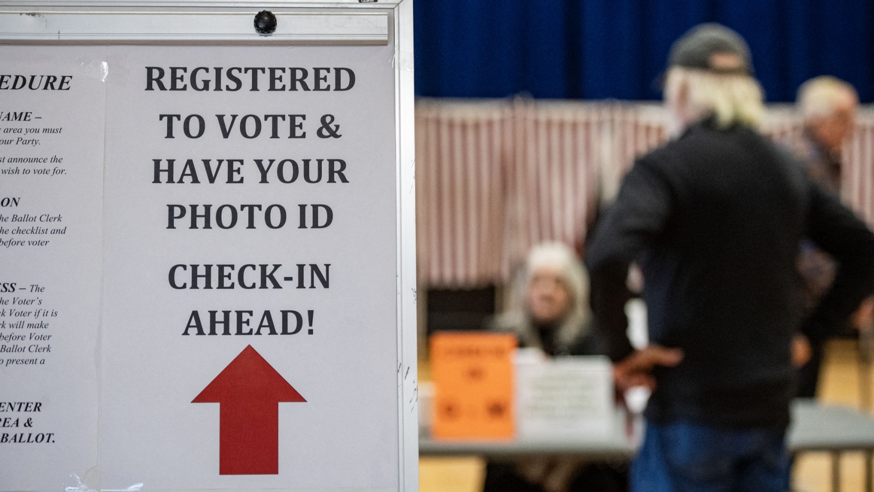 A sign informs voters to have their ID ready to check in on Election Day at the town offices in Lancaster, New Hampshire on November 5, 2024.