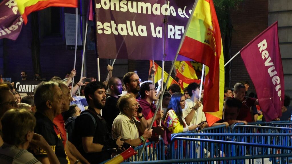 Demonstrators gather near the Spanish Socialist Worker's Party (PSOE) headquarters in Madrid to demand the resignation of Spain's Prime Minister Pedro Sánchez in Madrid, on June 13, 2025.
