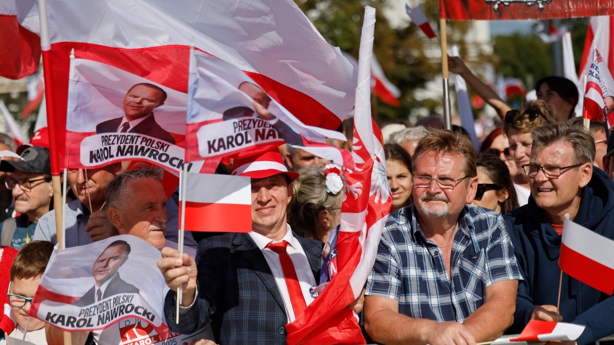 Supporters of President Karol Nawrocki wait for him to arrive for an official ceremony to assume command of the Armed Forces at the Tomb of the Unknown Soldier on the Pilsudski Square in Warsaw on August 6, 2025.