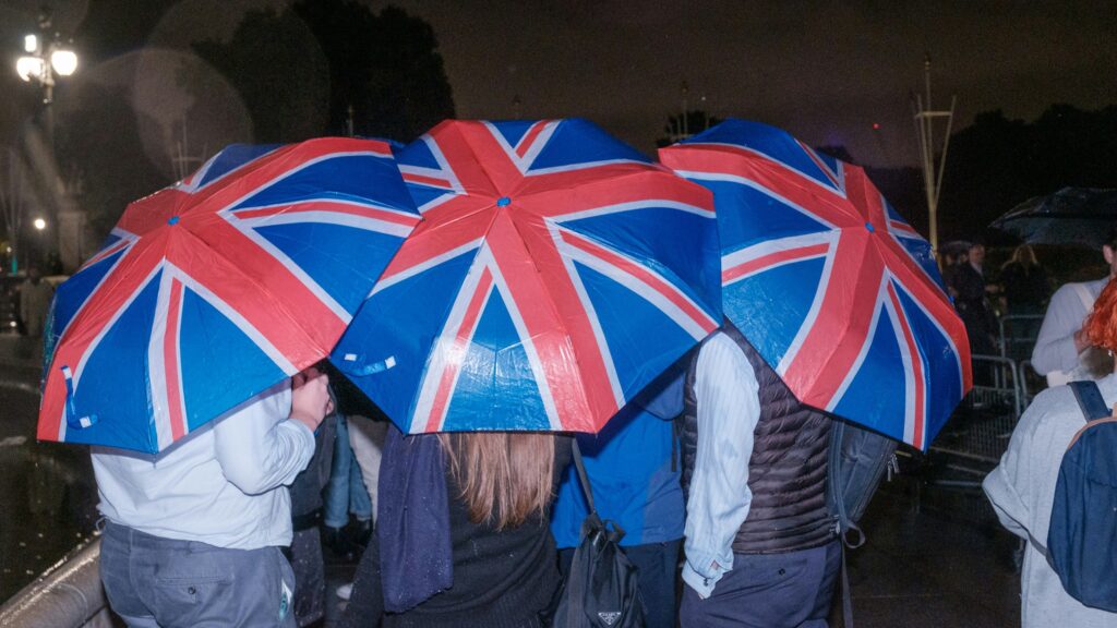Young people behind UK-flag themed umbrellas