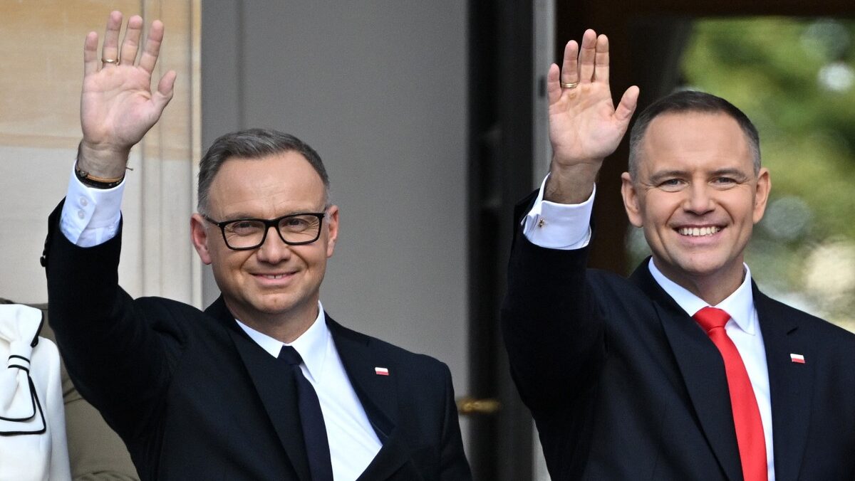 Ex president and new president smiling and waving