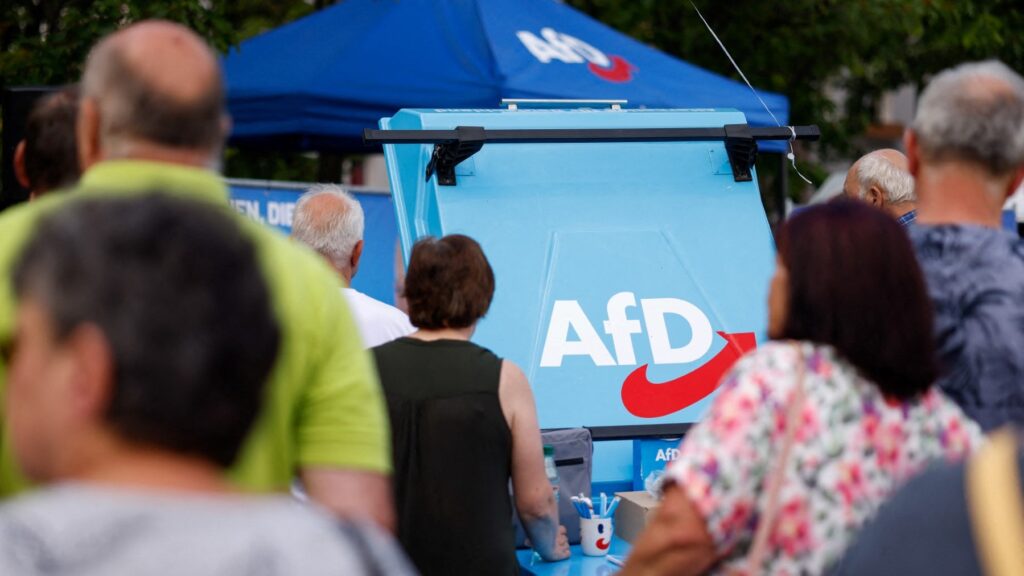The AfD logo is seen on a stand as supporters gather for an AfD election campaign meeting in Weisswasser, Saxony, on August 14, 2024.