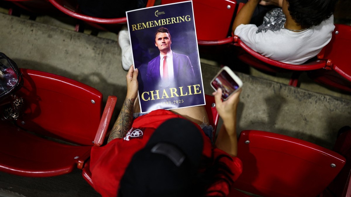 An attendee holds a flyer during a vigil in memory of Charlie Kirk at Desert Financial Arena on the campus of Arizona State University in Tempe, Arizona, on September 15, 2025.