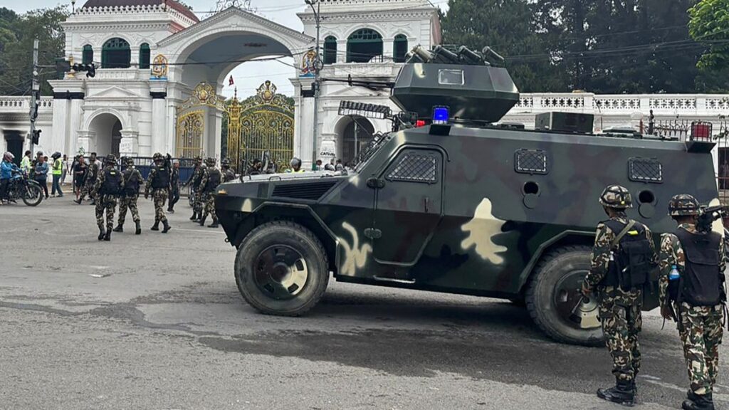Soldiers patrol a street outside the Singha Durbar, the main administrative building for the Nepal government, in Kathmandu on September 10, 2025.