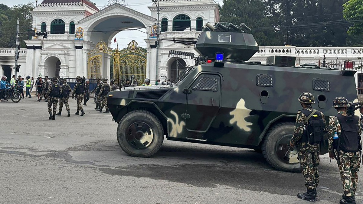 Soldiers patrol a street outside the Singha Durbar, the main administrative building for the Nepal government, in Kathmandu on September 10, 2025.