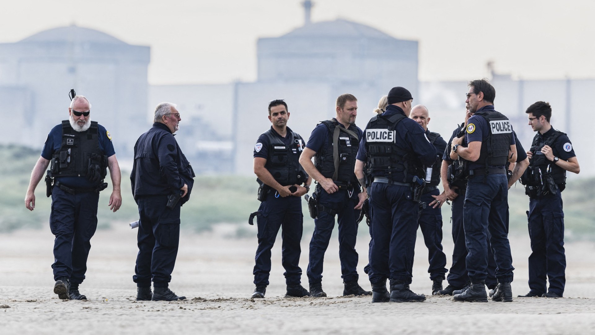 French police and French border police (PAF) officers patrol the beach as they search for migrants attempting to cross the English Channel to reach Britain, in Gravelines, northern France on July 20, 2024.