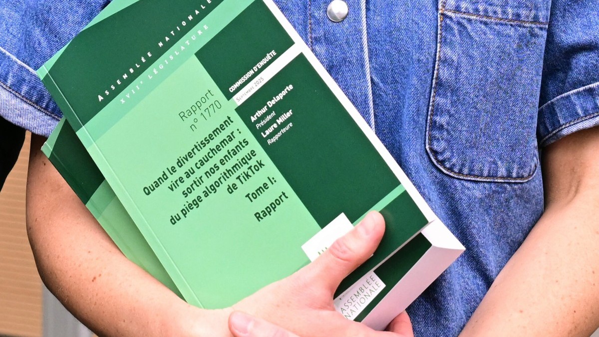 Ensemble Pour la République's MP Laure Miller holds copies of a report to the parliamentary commission of inquiry into the psychological effects of TikTok on minors, at the National Assembly in Paris on September 11, 2025.