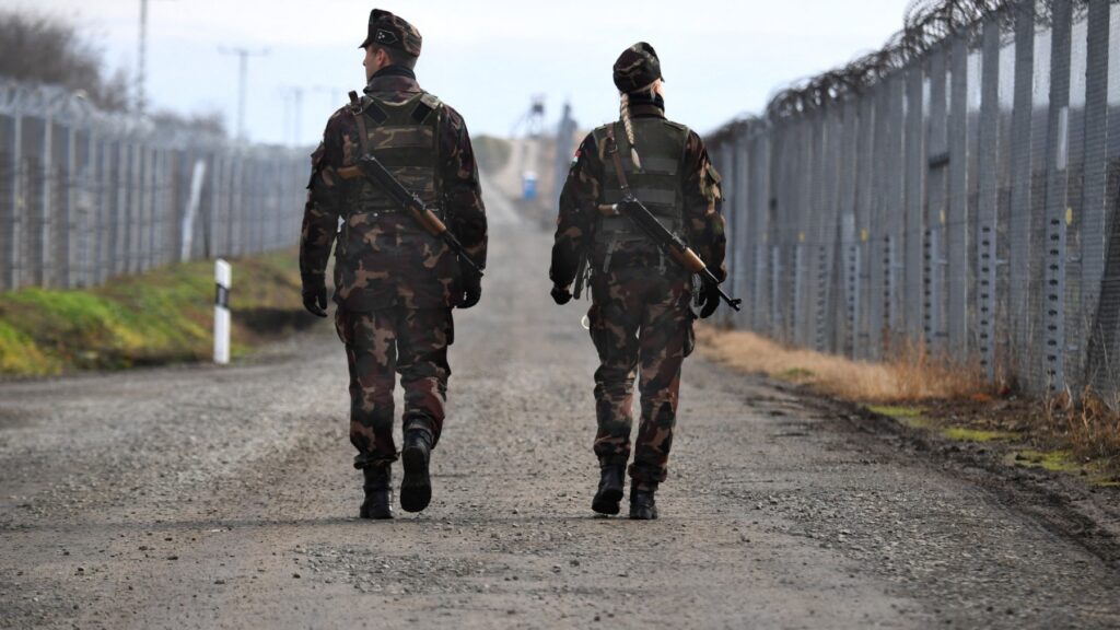 Border soldiers patrol along the border fence at the Hungarian-Serbian border near Hercegszántó on December 14, 2017.