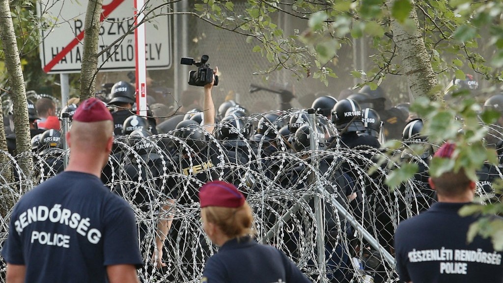 Hungarian riot police clash with migrants attempting to break out from the no-man’s land between the two countries at the Hungarian-Serbian border at Röszke on September 16, 2015.