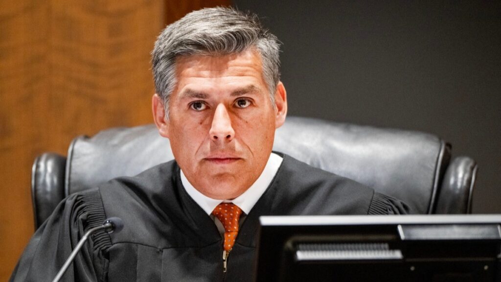 Judge Tony Graf of the 4th District Court listens to Salt Lake City criminal defense attorney Greg Skordas who appeared on behalf of Utah County, as Tyler Robinson, the suspect in the killing of political activist Charlie Kirk, attends a court appearance remotely from his jail cell in Provo, Utah, on September 16, 2025.