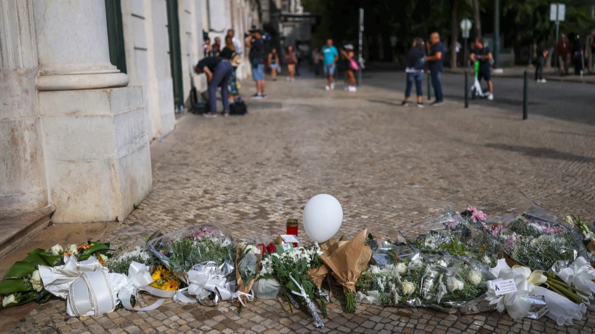 Flowers and tributes seen at the site of the Gloria funicular accident after the wreckage was removed in Lisbon on September 5, 2025.