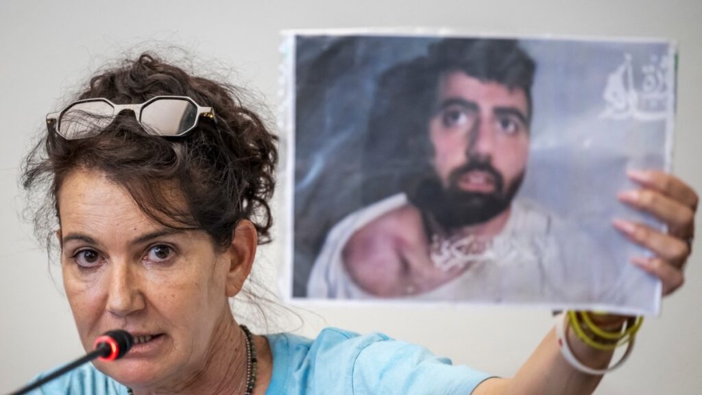 Merav Gilboa-Dalal shows an image of her son, Israeli hostage Guy Gilboa-Dalal as she speaks at a press conference following a meeting with the president of the International Committee of the Red Cross (ICRC) in Geneva, on August 12, 2025.