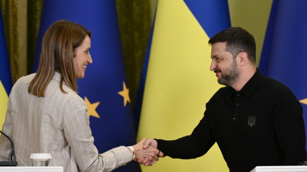 Ukraine’s President Volodymyr Zelensky (R) and European Parliament President Roberta Metsola (L) shake hands during a press conference following talks in Kyiv on September 17, 2025