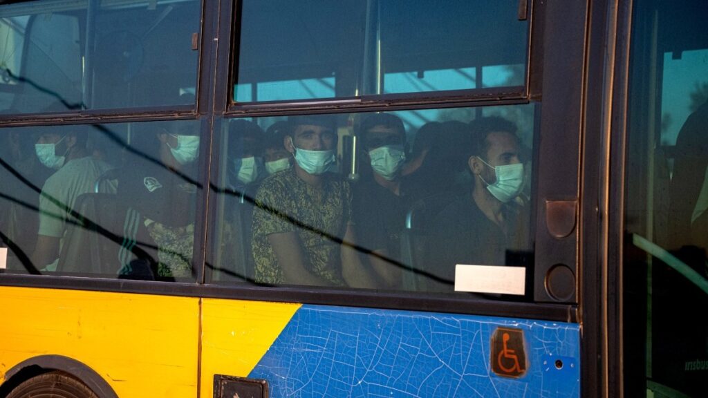 Migrants on their way to a detention centre after being rescued by Coast Guard off the Greek islands of Crete and Gavdos on July 21, 2025.