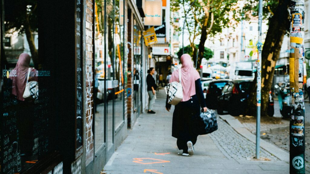 Mulsim woman walking on German street (Unsplash)