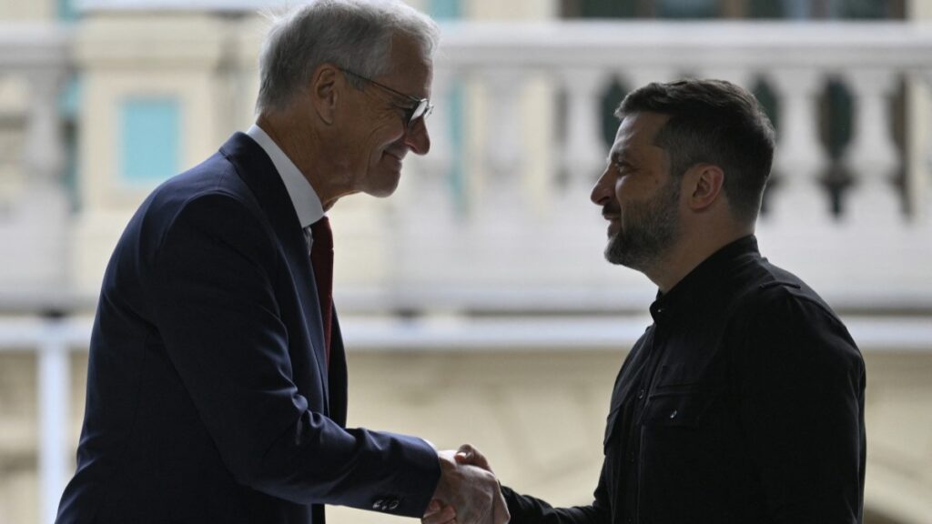 Ukrainian President Volodymyr Zelensky (R) and Prime Minister of Norway Jonas Gahr Støre shake hands during their press-conference following the talks outside Mariyinsky Palace in Kyiv on August 25, 2025.