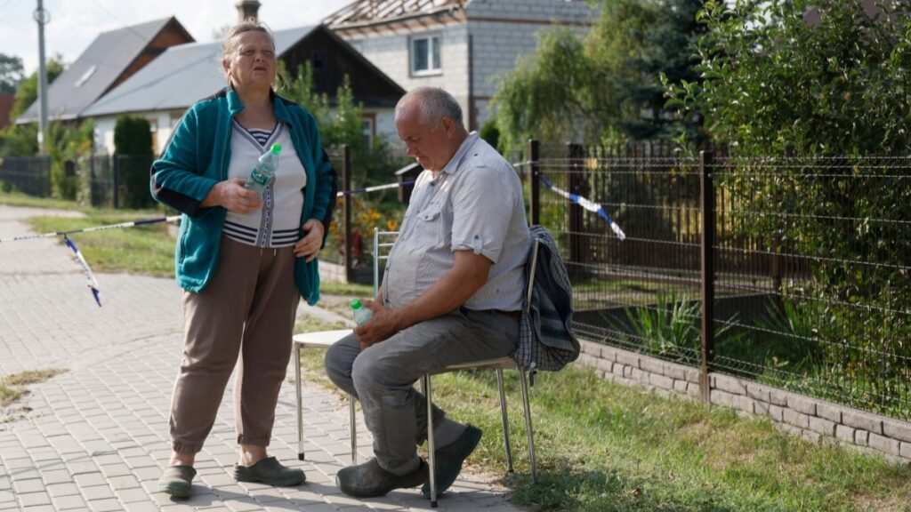 Alicja Wesolowska and her husband Tomasz Wesolowski in front of their damaged house reportedly destroyed by debris from a shot down Russian drone in the village of Wyryki-Wola, eastern Poland, on September 10, 2025.