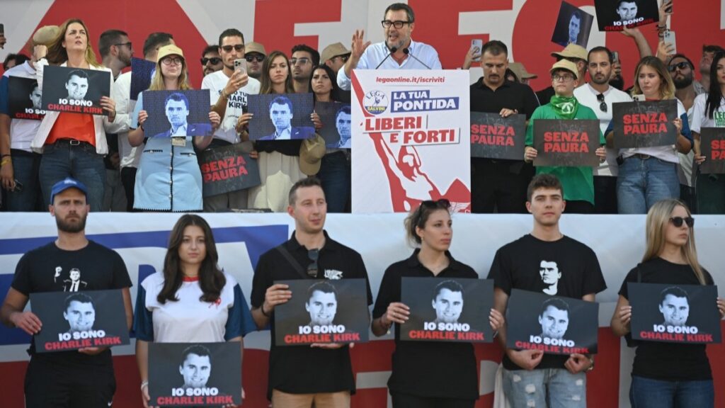 Lega party leader Matteo Salvini speaks on stage surrounded by supporters holding portraits of Charlie Kirk and posters reading "Without Fear" during party’s annual rally in Pontida, Italy on September 21, 2025.