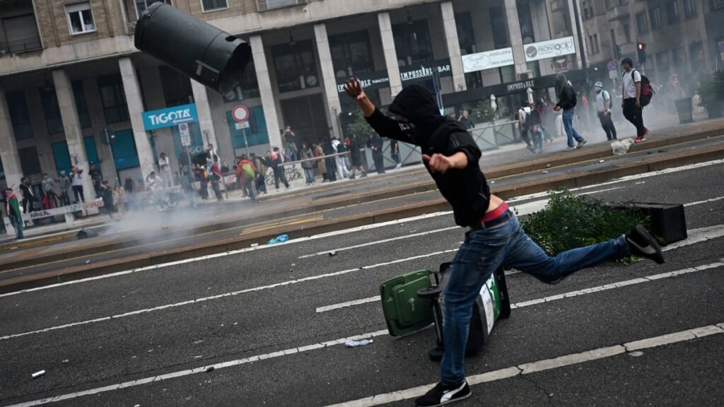 A protester is hurling a bin at riot police near Milano Centrale train station during a violent demonstration on the sidelines of a nationwide strike organized by the Unione Sindacale di Base (USB Union) in Milan on September 22, 2025.
