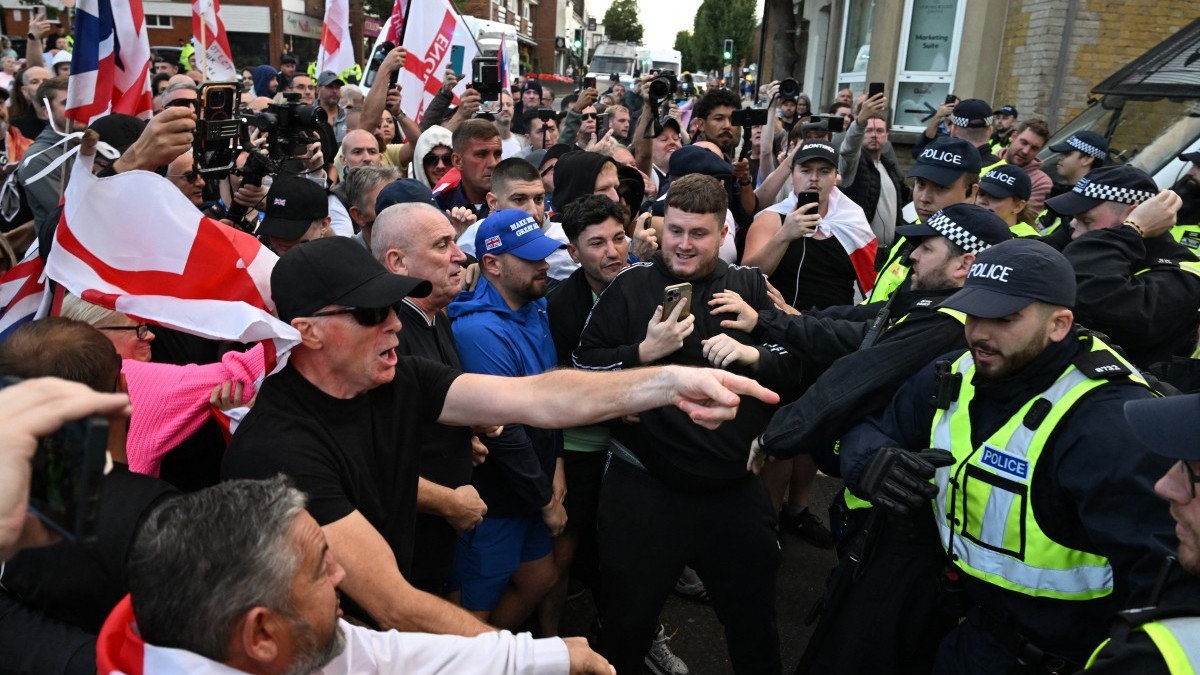 Police officers and protesters scuffle outside the council offices in Epping after a march from the Bell Hotel which houses asylum seekers, on August 31, 2025.