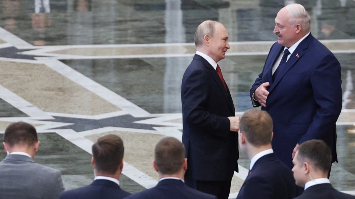 Russia’s President Vladimir Putin interacts with Belarusian President Alexander Lukashenko prior to a meeting of the Supreme Eurasian Economic Council at the Independence Palace in Minsk on June 27, 2025.