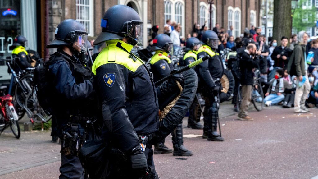 Riot police stand by at the University of Amsterdam stand as thousands take part in a pro-Palestinian protest in Amsterdam on May 9, 2024.