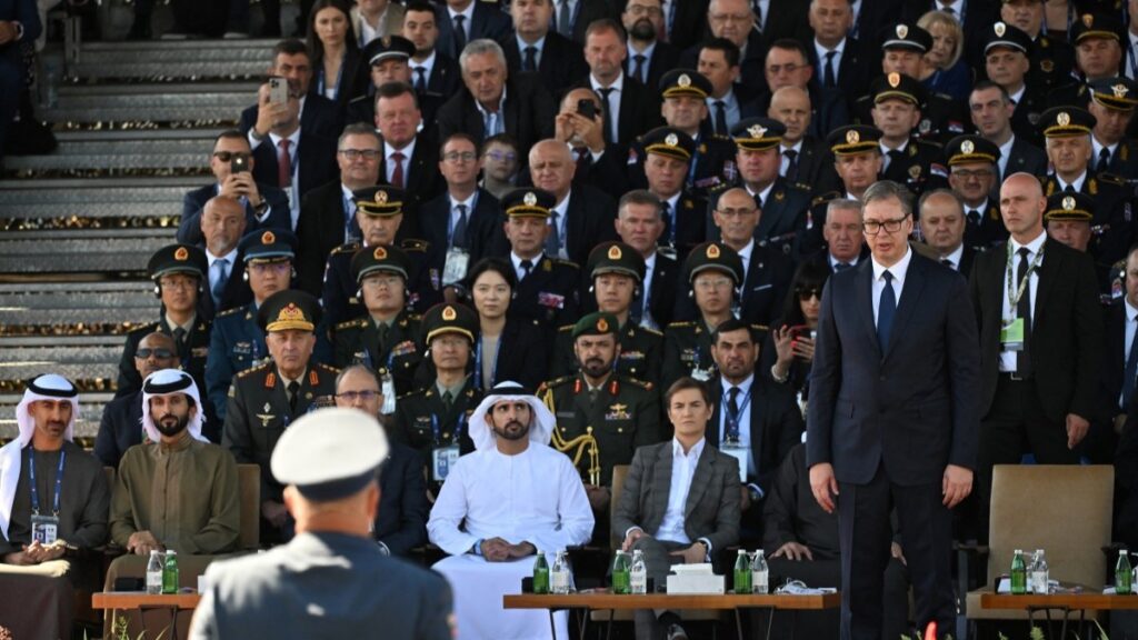 Serbian President Aleksandar Vučić (standing, R) attends an annual military parade in Belgrade on September 20, 2025.