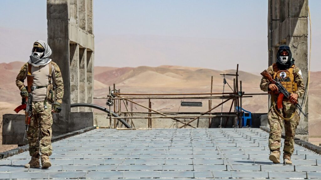 Taliban security personnel stand over the Pashdan Dam, also known as Band-e Pashdan, in the Karukh district of Herat province on August 31, 2025.