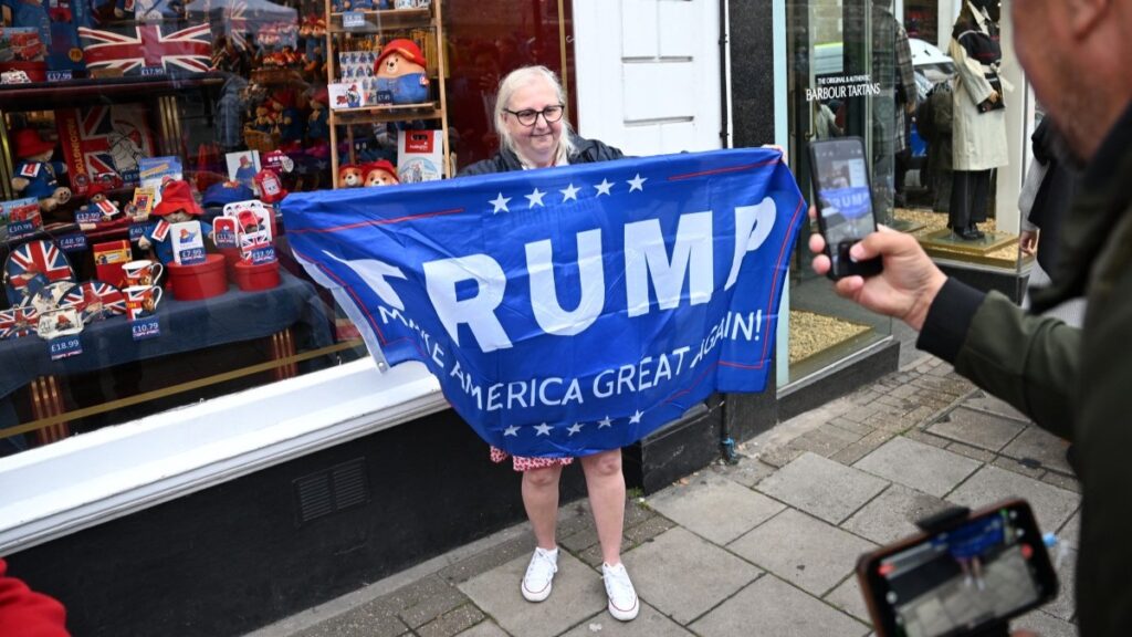 A person holds a banner reading “Trump, Make America Great Again” near Windsor Castle, in Windsor, on September 17, 2025, during US President Donald Trump's second State Visit to the UK.