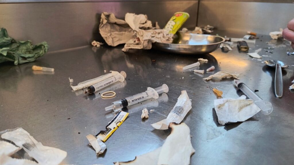 Used needles and other waste seen on a stainless steel table in the drug consumption room at Frankfurt am Main's main railway station on April 30, 2025