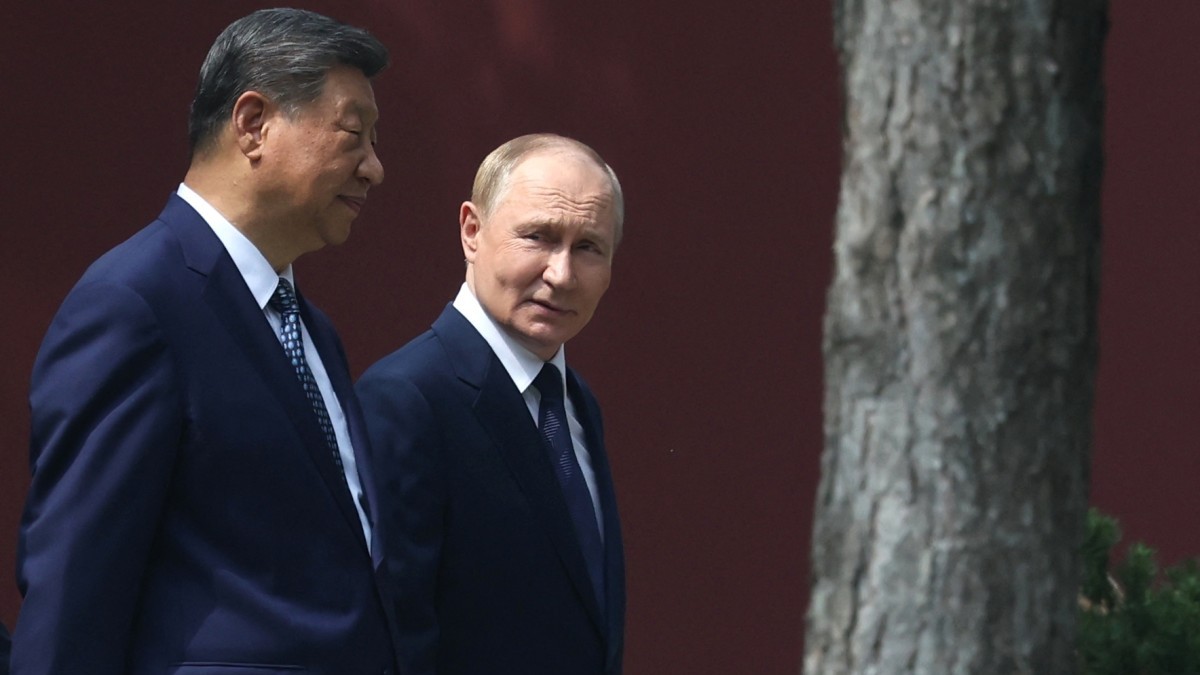 Russia's President Vladimir Putin and China's President Xi Jinping walk at Zhongnanhai leadership compound in Beijing on September 2, 2025.
