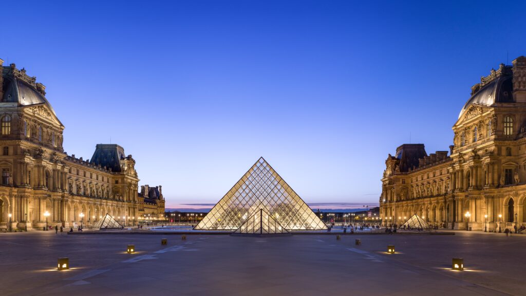 The Louvre Museum's Napoleon Courtyard at dusk