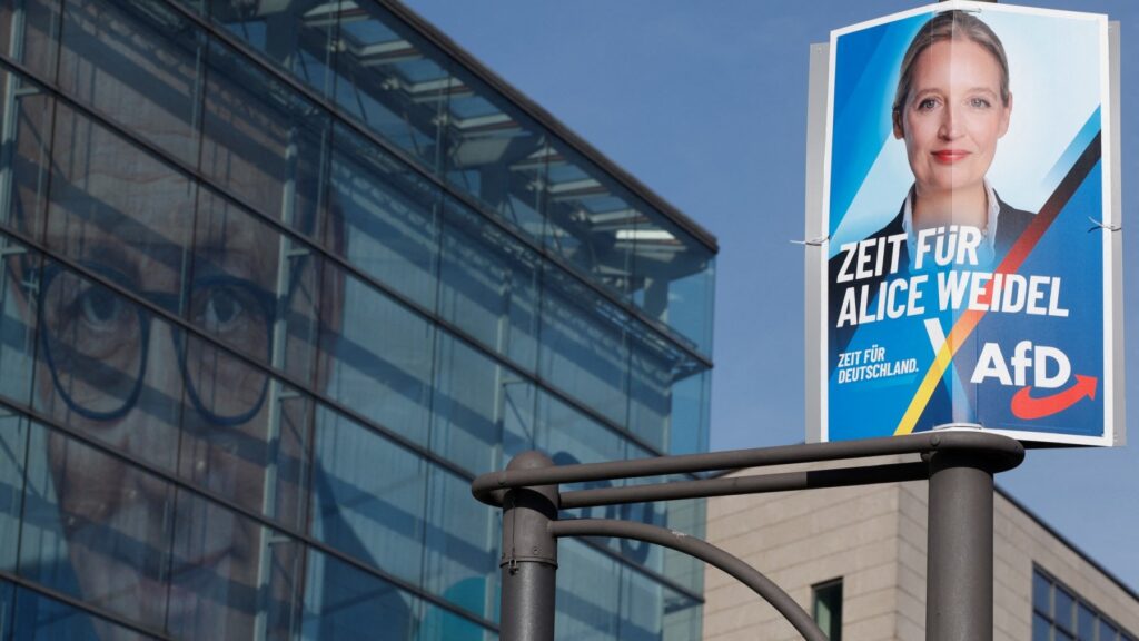 An election poster of AfD co-chair Alice Weidel (R) is seen in front of the headquarters of the CDU, with a giant picture CDU top candidate and leader Friedrich Merz on its facade in Berlin on February 24, 2025.
