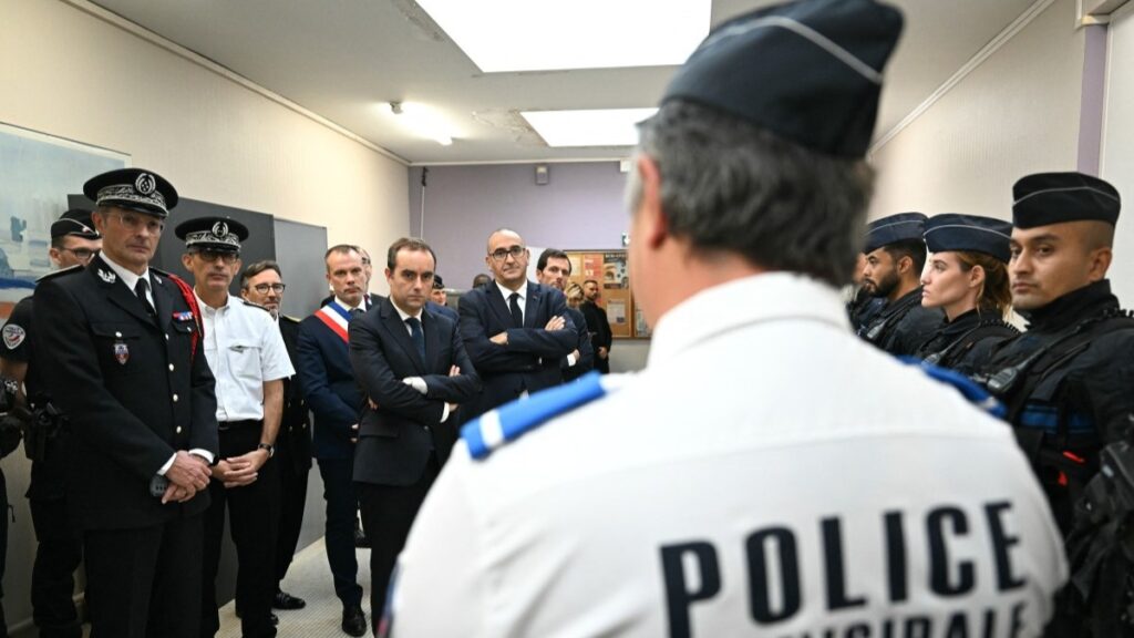 France's Prime Minister Sébastien Lecornu (C), next to Paris Police Prefect Laurent Nunez (C-R), meets police officers during a visit to a police station in L'Hay-les-Roses, on the southern outskirts of Paris on October 11, 2025.