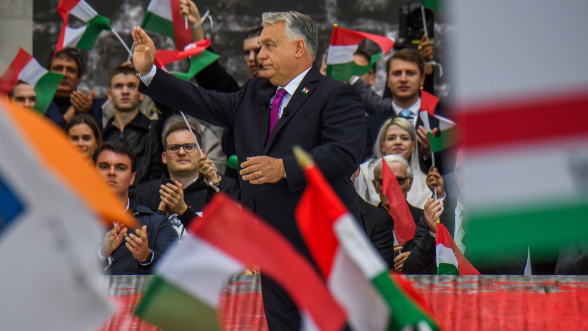 Hungarian Prime Minister Viktor Orbán waves to his supporters in front of the Hungarian Parliament in Budapest on October 23, 2025.