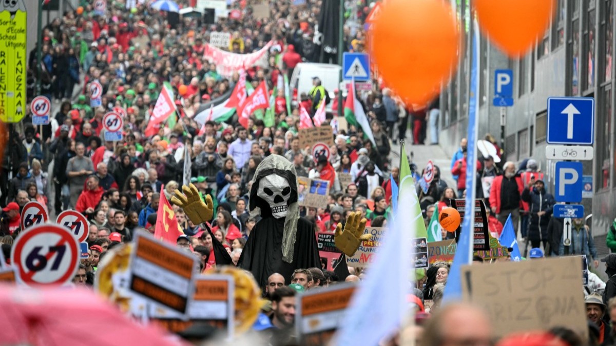 Protesters take part in a demonstration during a national day of action against the austerity of the federal Arizona government, in Brussels on October 14, 2025.