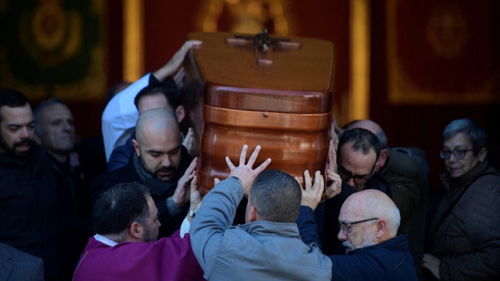 On January 27, 2023, pallbearers carry the casket of late sacristan Diego Valencia after a funeral mass at the Nuestra Senora de La Palma church on Alta Square, Algeciras, where he was killed on January 25 by Moroccan Yassine Kanjaa.