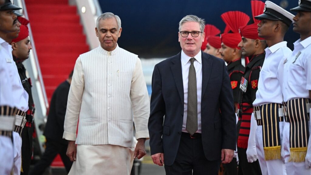 Britain's Prime Minister Keir Starmer (R) arrives at Chhatrapati Shivaji Maharaj International Airport in Mumbai on October 8, 2025.