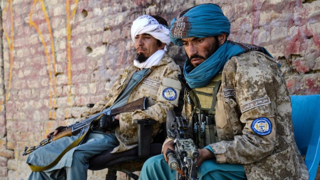 Armed Taliban security personnel keep guard beside the closed gate of the zero point border crossing between Afghanistan and Pakistan at Spin Boldak district in Kandahar province on October 12, 2025.
