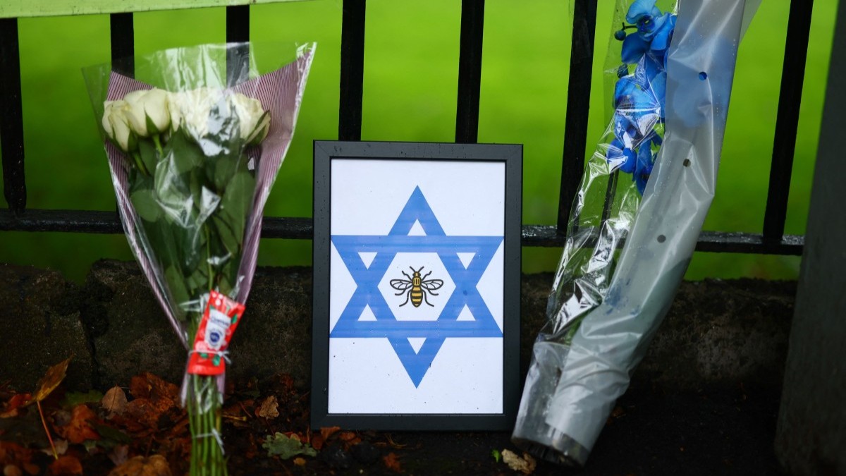 Flowers and a tribute featuring a bee and a Star of David near Heaton Park Hebrew Congregation synagogue in Crumpsall, north Manchester, on October 3, 2025, following an attack at the synagogue yesterday.