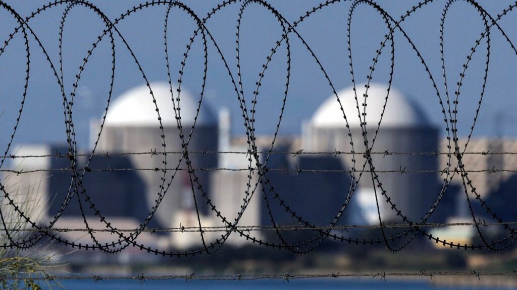 Concertina wire is seen on a fence surrounding the Almaraz nuclear power plant in Almaraz, western Spain, on June 26, 2025.