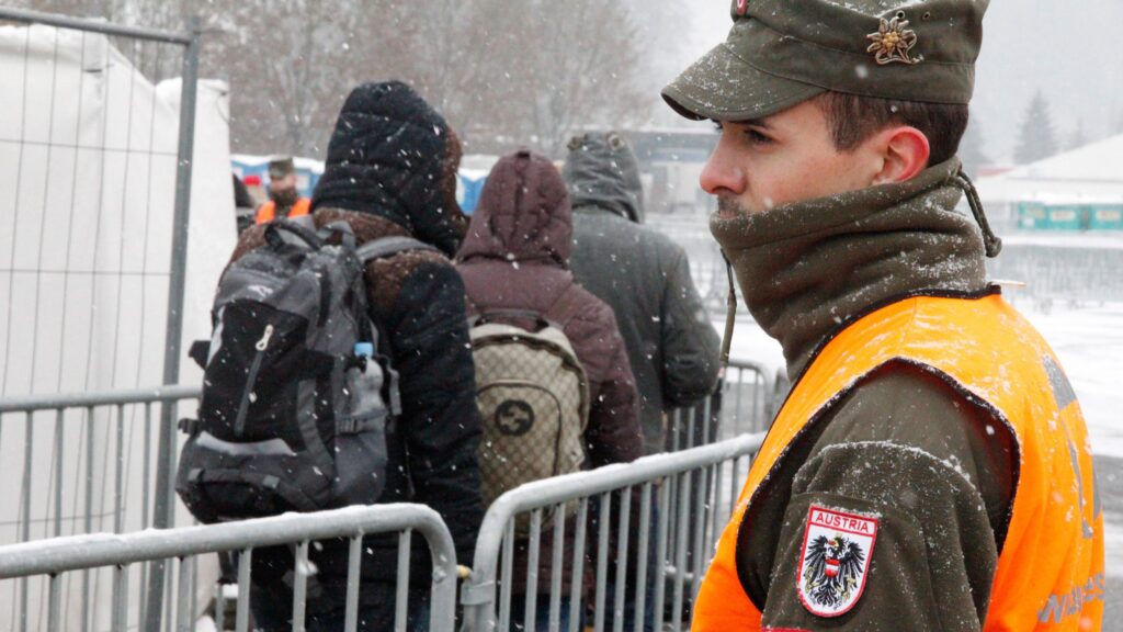 A member of the Austrian armed forces (Bundesheer) looks on as refugees cross the border at Spielfeld on January 4, 2016.