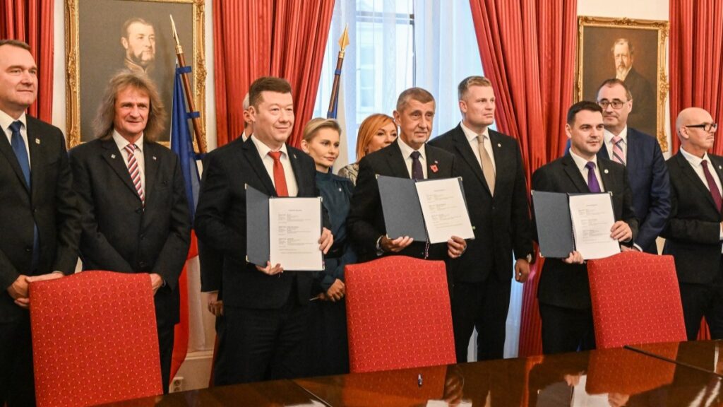ANO leader and prime minister candidate Andrej Babiš (C) poses with his coalition partners after signing a new coalition government agreement at the Czech Parliament in Prague on November 3, 2025.